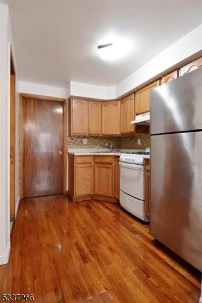 kitchen featuring stainless steel refrigerator, tasteful backsplash, dark hardwood / wood-style floors, and gas range gas stove