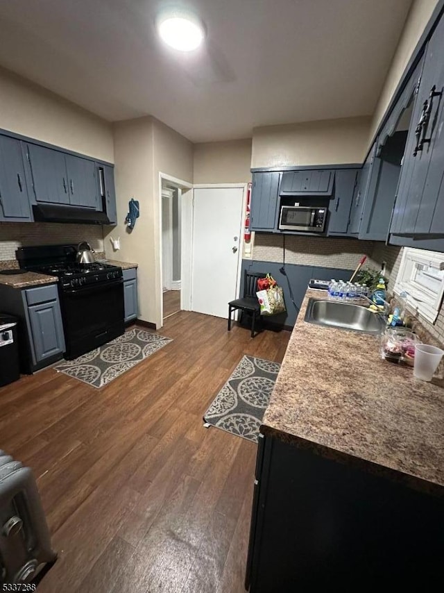 kitchen featuring sink, dark wood-type flooring, and black range with gas stovetop