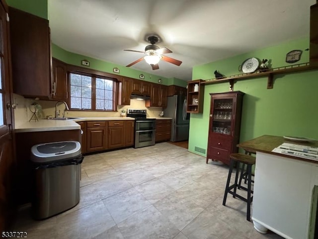 kitchen featuring open shelves, stainless steel appliances, a ceiling fan, a sink, and under cabinet range hood