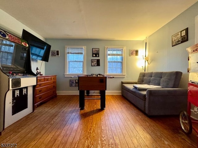 rec room featuring wood-type flooring and baseboards