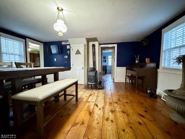 dining area featuring a wood stove and hardwood / wood-style flooring