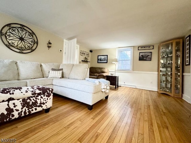 living room featuring wood-type flooring and baseboards