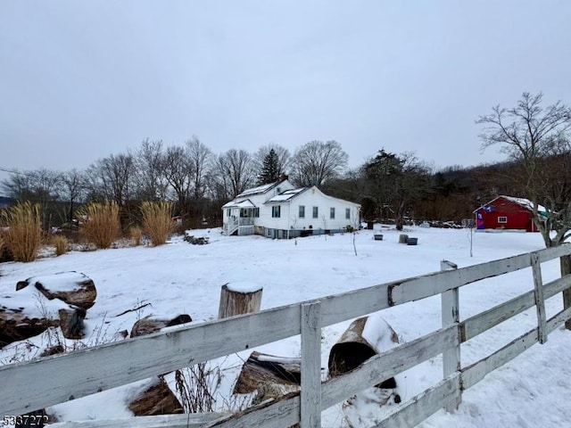 yard covered in snow with fence