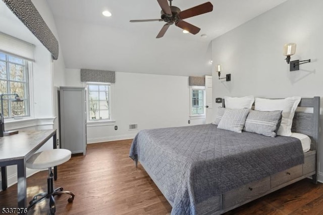 bedroom with dark wood-type flooring, vaulted ceiling, and ceiling fan