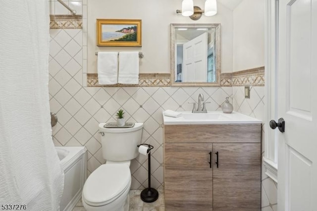 full bathroom featuring shower / bath combination with curtain, vanity, toilet, and tile walls