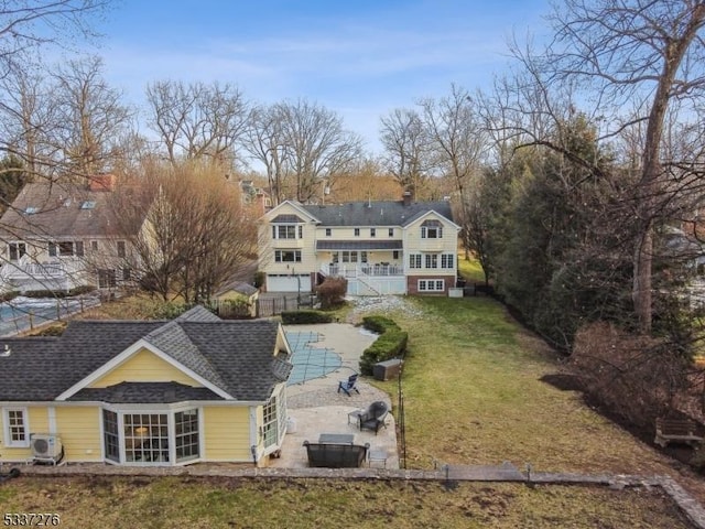 rear view of house with a yard, ac unit, a patio, and a covered pool