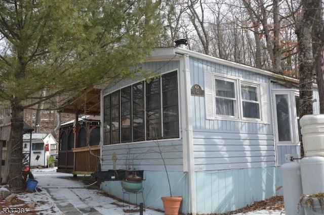 view of property exterior featuring a sunroom