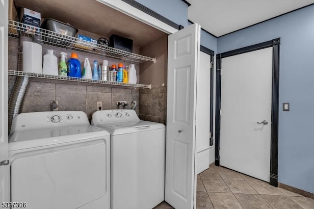 laundry room with light tile patterned floors and washing machine and clothes dryer