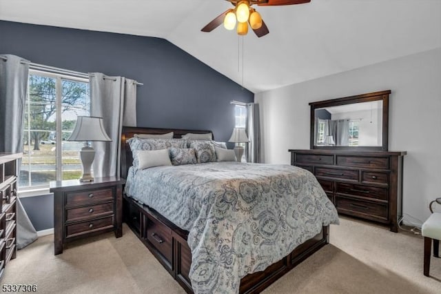 carpeted bedroom with ceiling fan, vaulted ceiling, and multiple windows