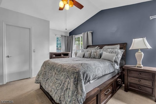 bedroom with vaulted ceiling, light carpet, and ceiling fan