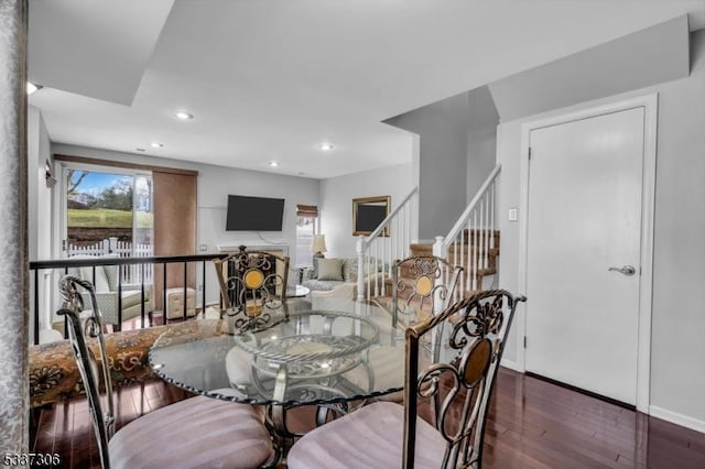 dining area with dark hardwood / wood-style flooring