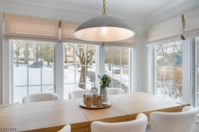 dining space featuring crown molding