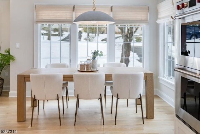 dining space featuring light wood-type flooring