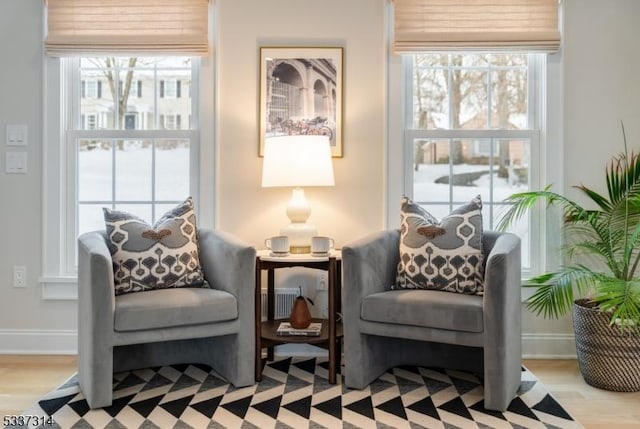 sitting room featuring light hardwood / wood-style floors and a healthy amount of sunlight