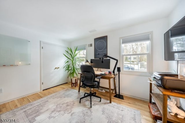 office with light wood-type flooring