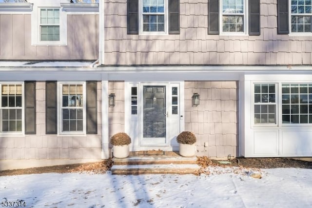 view of snow covered property entrance