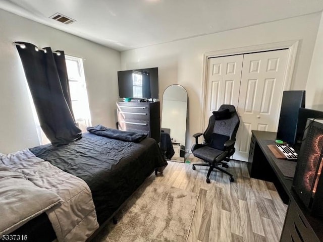 bedroom featuring a closet and light hardwood / wood-style flooring