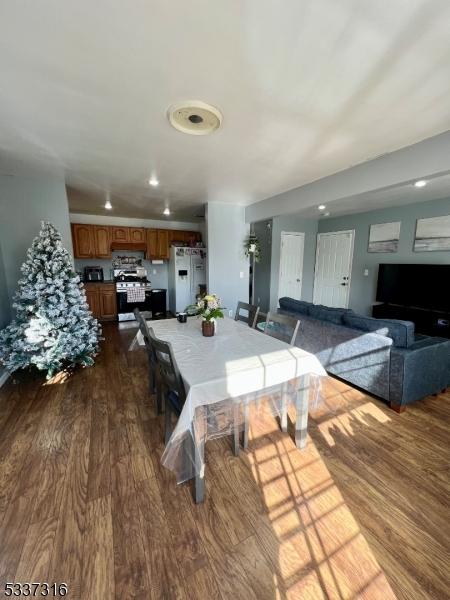 dining space with dark wood-type flooring