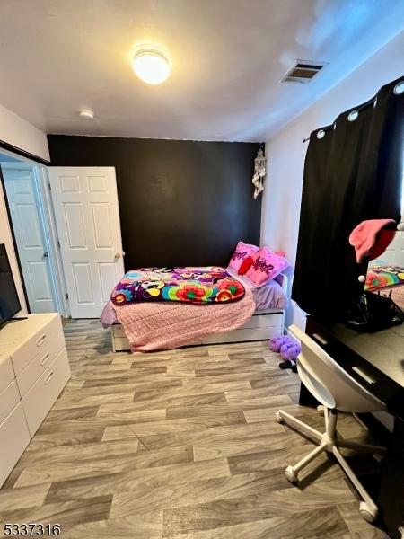 bedroom with light wood-type flooring