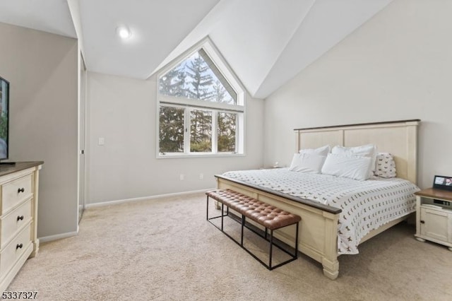 carpeted bedroom featuring lofted ceiling