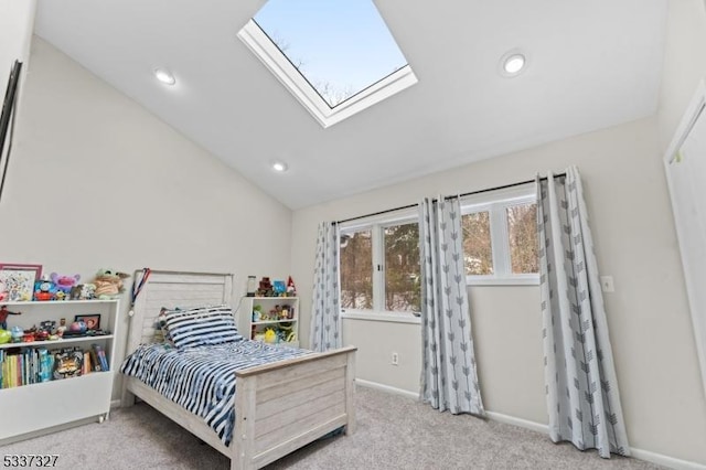 carpeted bedroom featuring lofted ceiling with skylight