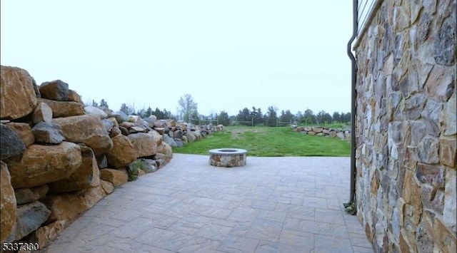 view of patio with a fire pit