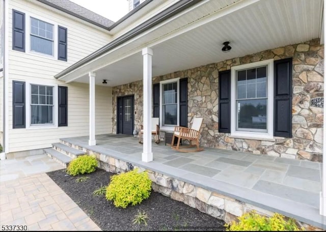 view of exterior entry with covered porch