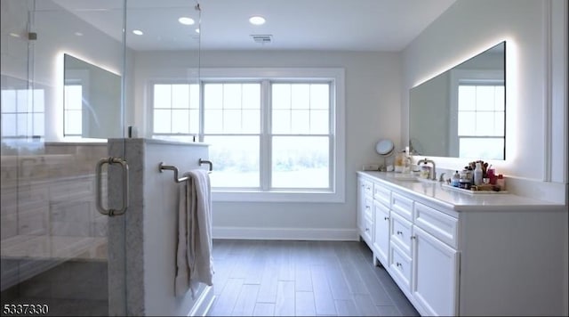 bathroom featuring a shower with door, vanity, and hardwood / wood-style flooring