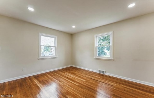 spare room featuring hardwood / wood-style floors