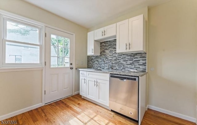 kitchen featuring white cabinetry, light hardwood / wood-style flooring, tasteful backsplash, and dishwasher