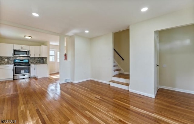 unfurnished living room featuring light wood-type flooring