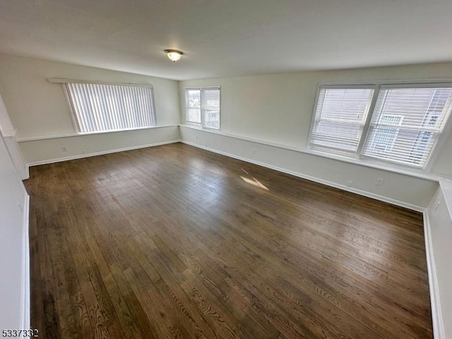 spare room featuring dark wood-type flooring