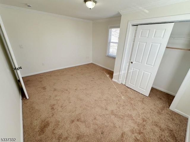 unfurnished bedroom with light carpet, ornamental molding, and a closet