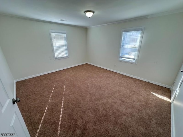 carpeted empty room featuring ornamental molding