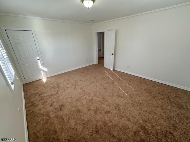 unfurnished room featuring ornamental molding and carpet flooring