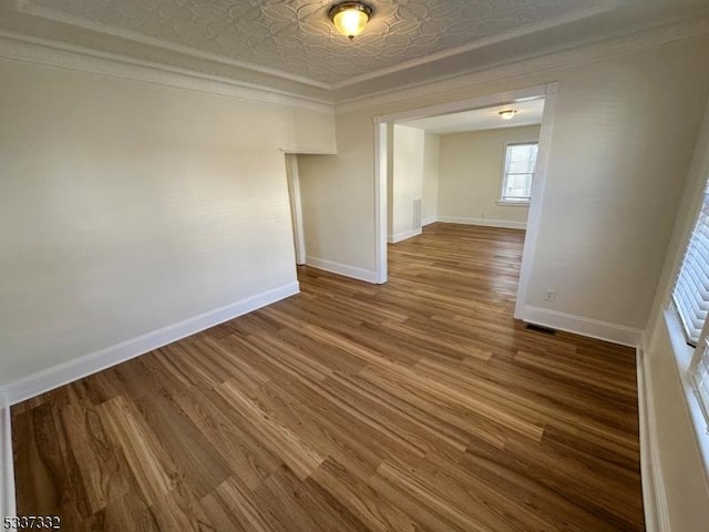 spare room featuring ornamental molding and hardwood / wood-style floors