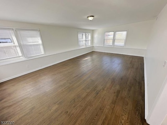 empty room featuring dark wood-type flooring