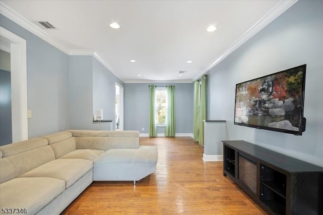 living room with ornamental molding and light wood-type flooring