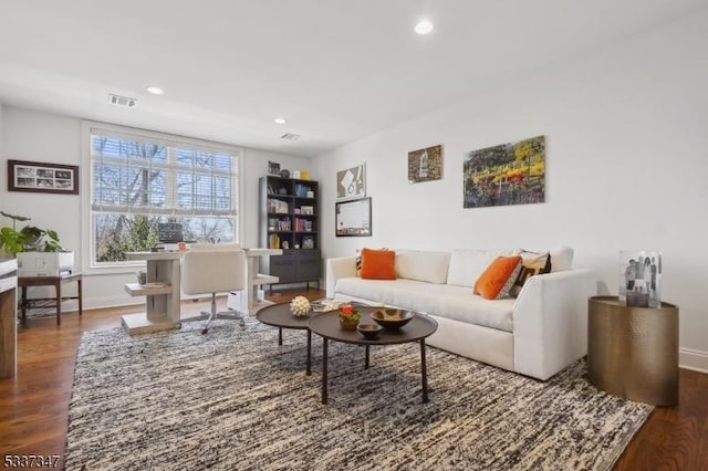 living area featuring baseboards, visible vents, dark wood finished floors, and recessed lighting