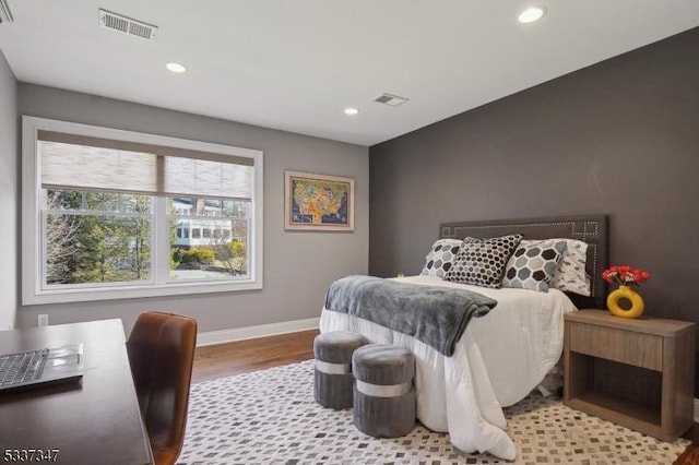 bedroom with light wood-style floors, baseboards, visible vents, and recessed lighting