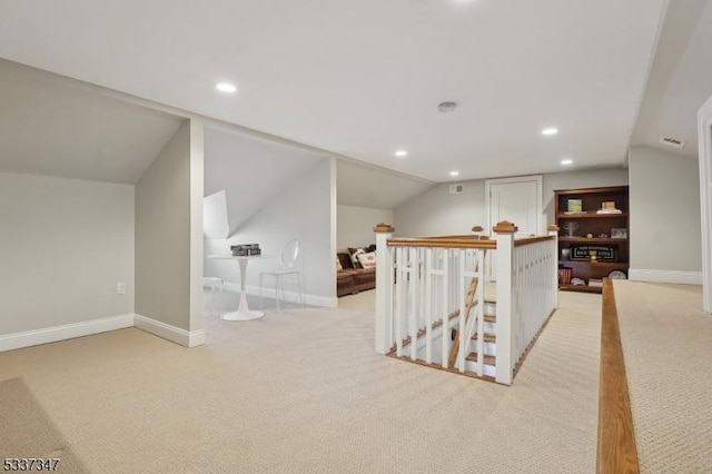 additional living space with lofted ceiling, recessed lighting, light colored carpet, and baseboards