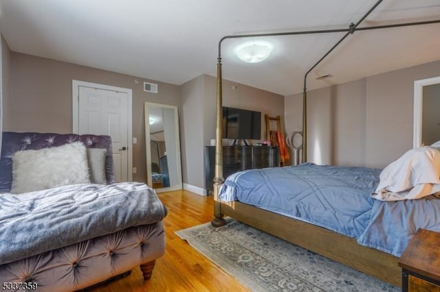 bedroom with visible vents and wood finished floors