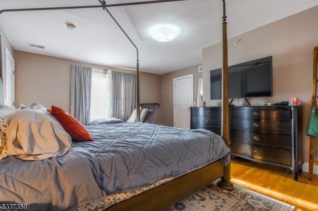 bedroom with visible vents and wood finished floors