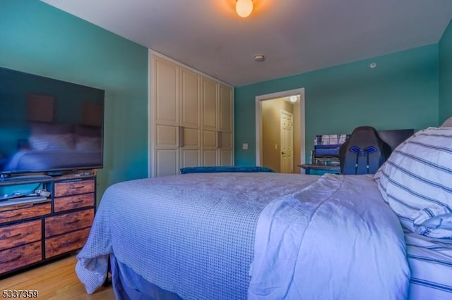 bedroom featuring light wood-style floors and a closet