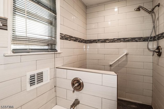 bathroom with tiled shower