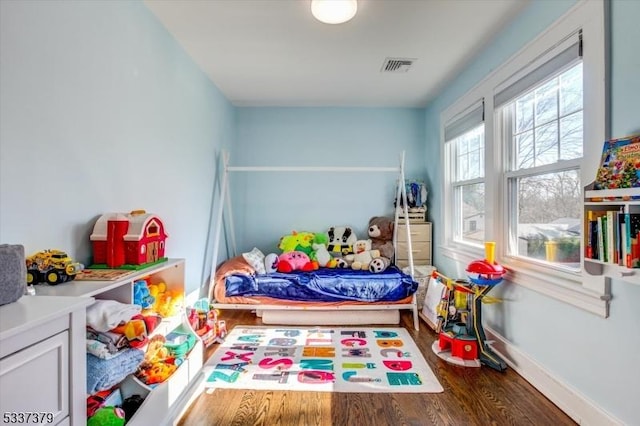 playroom featuring dark wood-type flooring