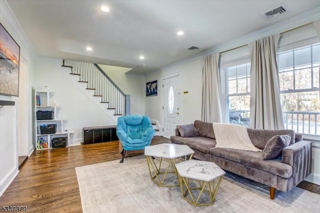 living room with wood-type flooring and crown molding