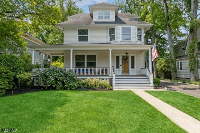 view of front of home featuring a front lawn and covered porch