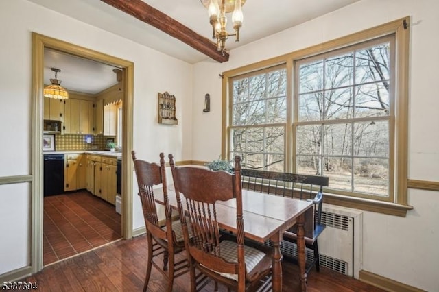 dining room featuring dark wood-style floors, radiator, a chandelier, and baseboards