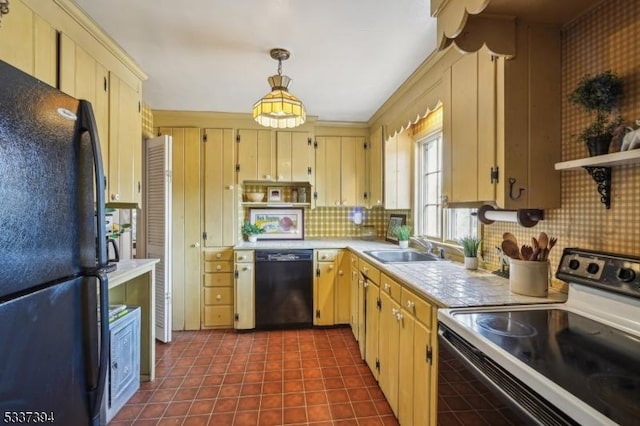 kitchen with open shelves, a sink, hanging light fixtures, light countertops, and black appliances